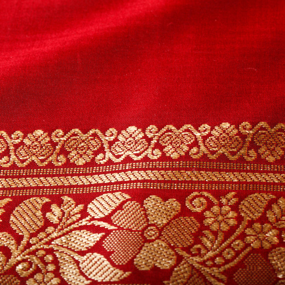 Gold thread in red fabric